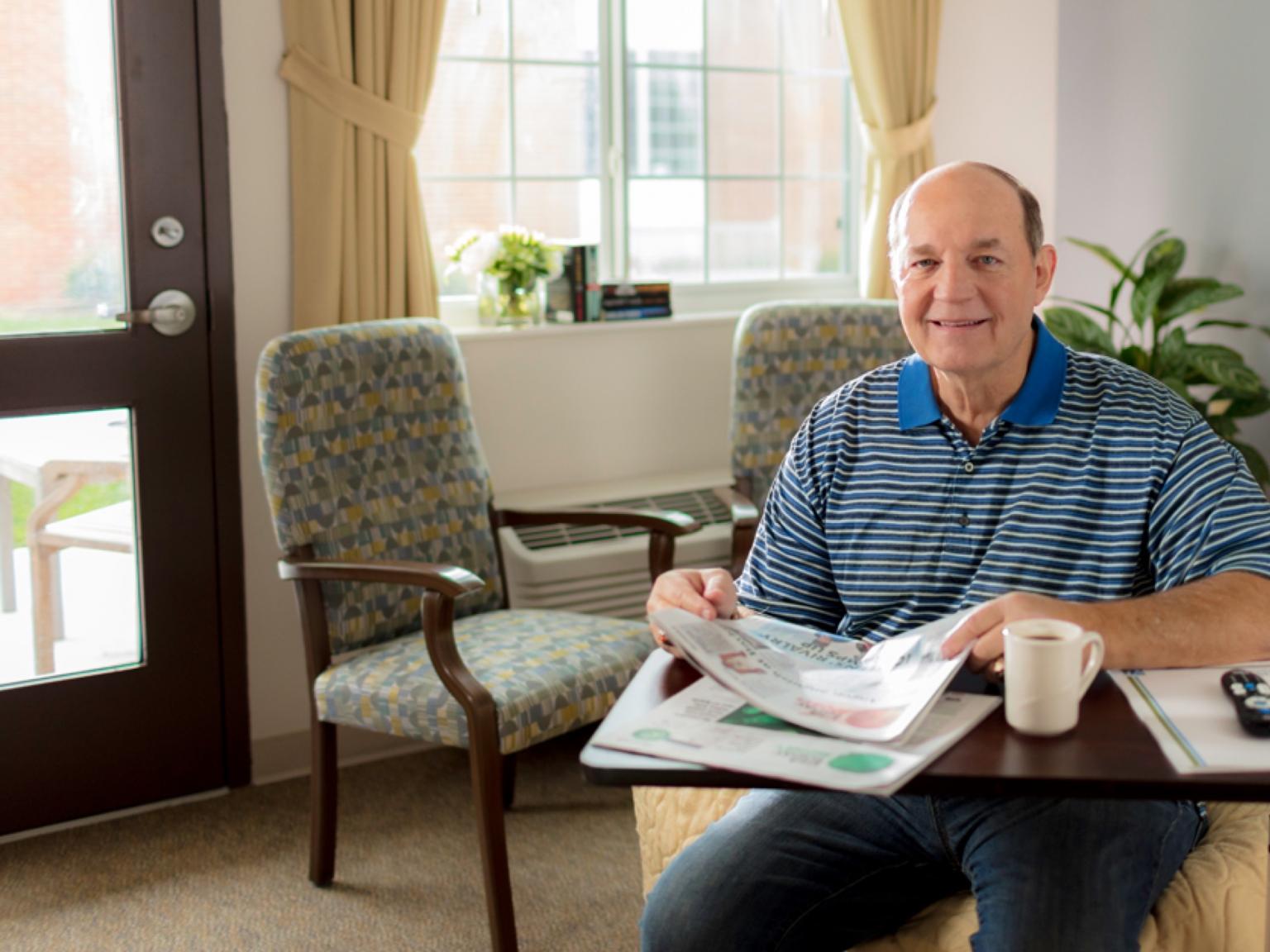 Kenneth reading in his room.