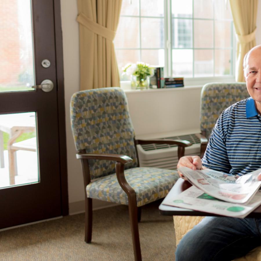 Kenneth reading in his room. 