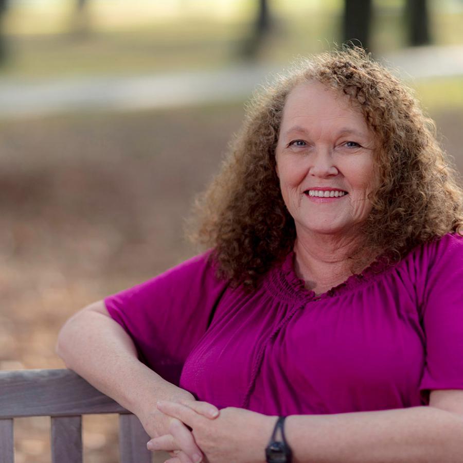 Lynda sitting on a bench